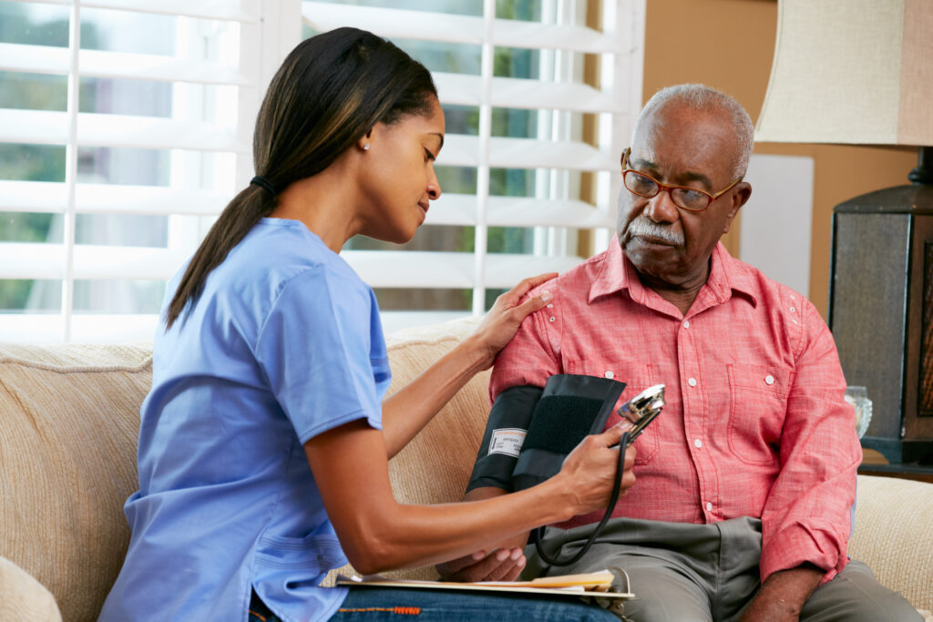 nurse checking hospice patient blood pressure