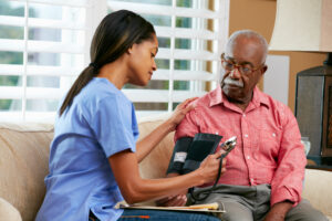 nurse checking hospice patient blood pressure